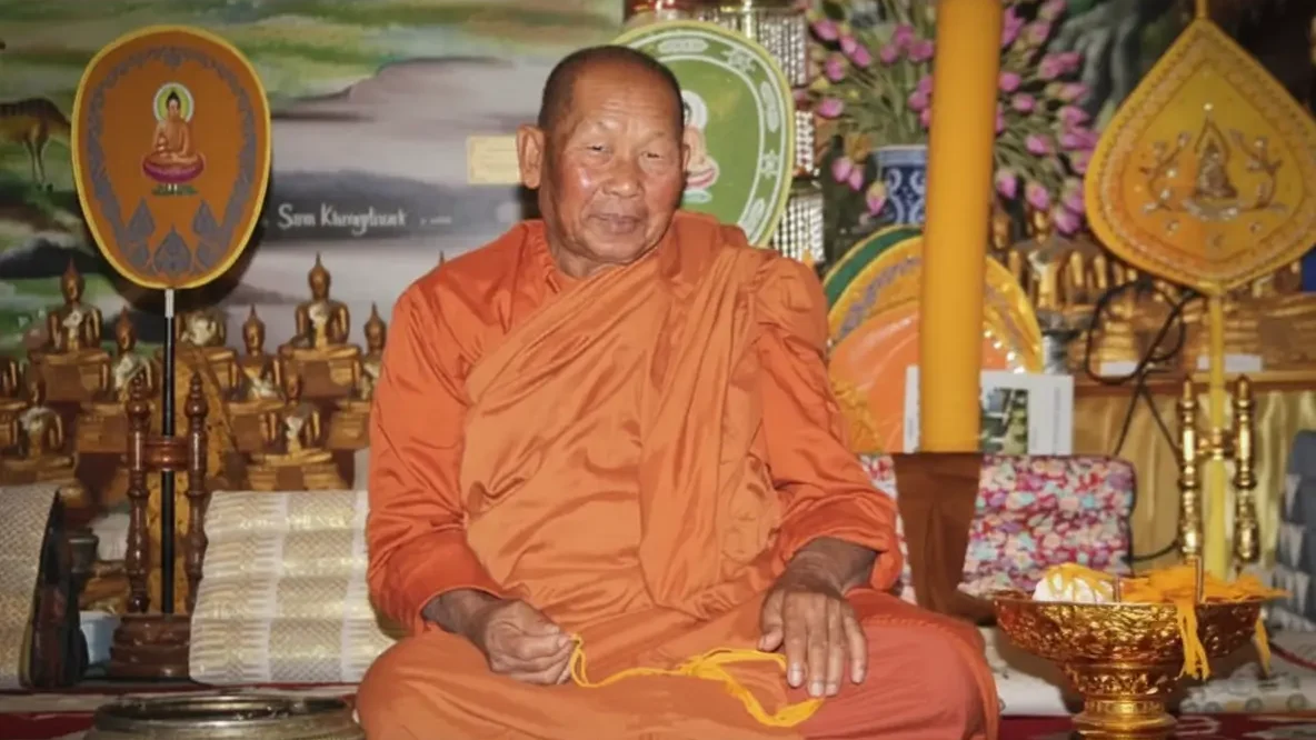 A Buddhist monk seated in a traditional temple, symbolizing a peaceful home for monks