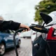 Woman charging electric car at charging station